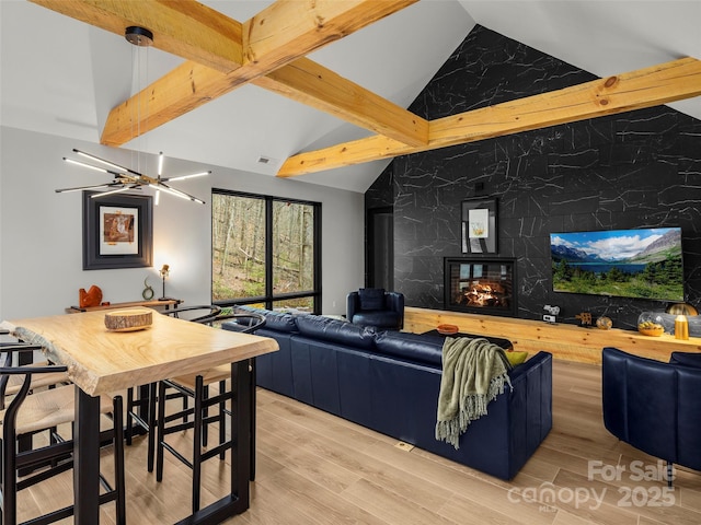 80 Hemlock Cir, Black Mountain, NC 28711 - living room featuring beam ceiling, a multi sided fireplace, light wood-type flooring, and high vaulted ceiling