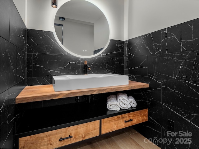 80 Hemlock Cir, Black Mountain, NC 28711 - bathroom featuring vanity, tile walls, wood finished floors, and decorative backsplash
