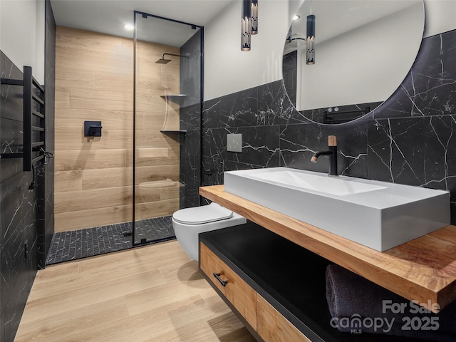 80 Hemlock Cir, Black Mountain, NC 28711 - bathroom with tile walls, tiled shower, toilet, and vanity