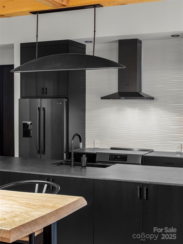 80 Hemlock Cir, Black Mountain, NC 28711 - kitchen with wall chimney range hood, stainless steel appliances, dark cabinets, tasteful backsplash, and light countertops