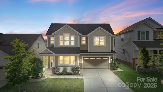 craftsman house featuring concrete driveway, a yard, an attached garage, and covered porch