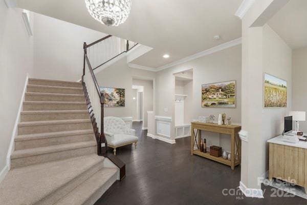 staircase featuring a chandelier, crown molding, recessed lighting, and baseboards