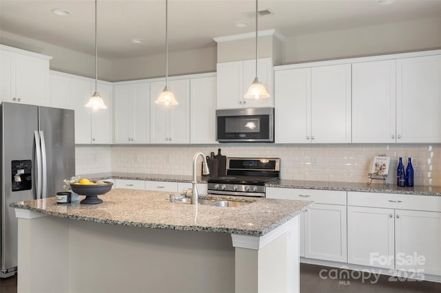 kitchen with a kitchen island with sink, decorative backsplash, appliances with stainless steel finishes, a sink, and visible vents