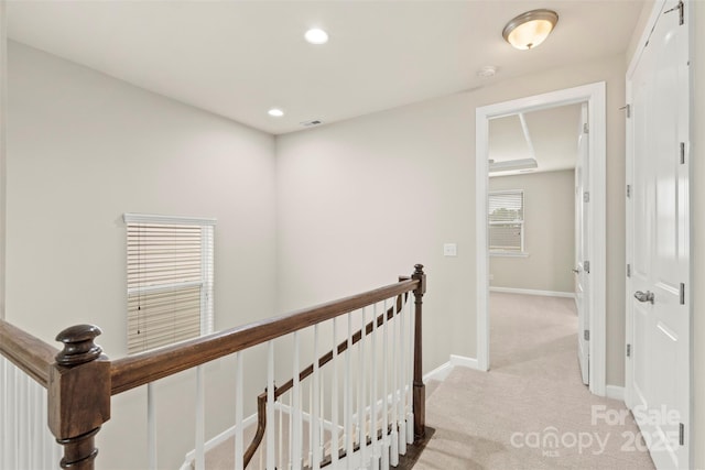 hall with recessed lighting, an upstairs landing, visible vents, light carpet, and baseboards