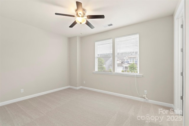 empty room featuring visible vents, baseboards, and light carpet