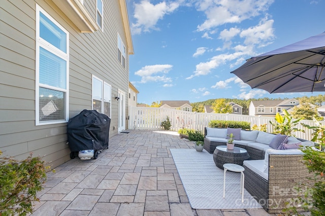 view of patio / terrace featuring an outdoor living space, a fenced backyard, and a grill