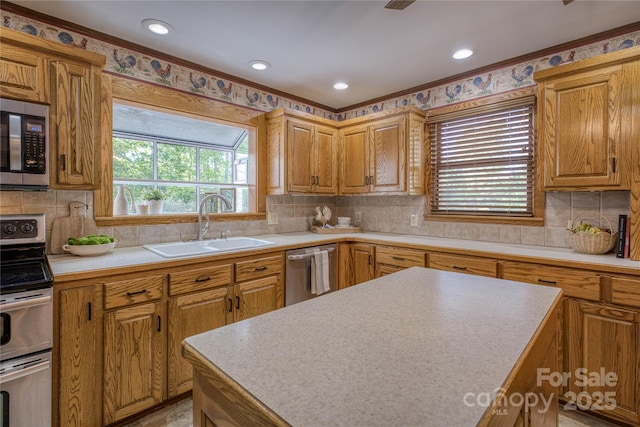 kitchen featuring decorative backsplash, brown cabinetry, a sink, light countertops, and stainless steel appliances