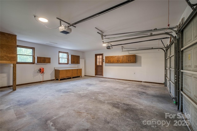 garage featuring baseboards and a garage door opener