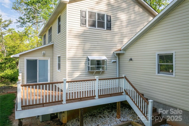 rear view of property featuring a deck