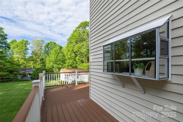 wooden terrace with a lawn