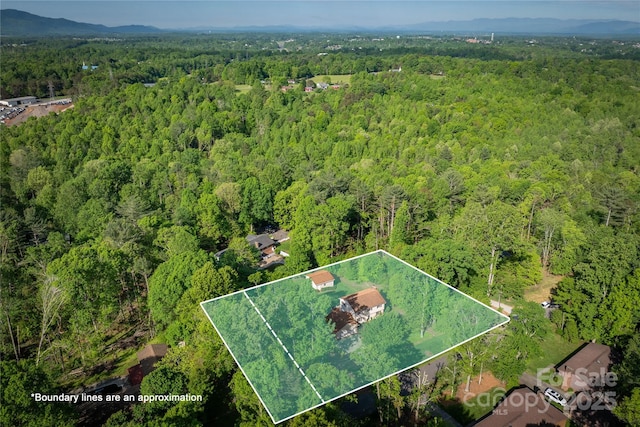 drone / aerial view with a view of trees