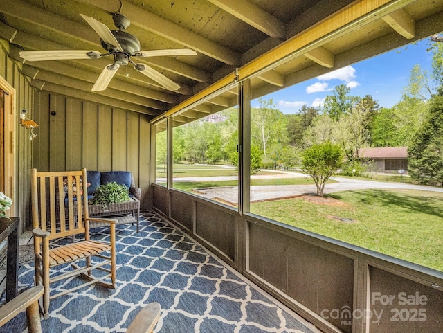 sunroom / solarium featuring ceiling fan
