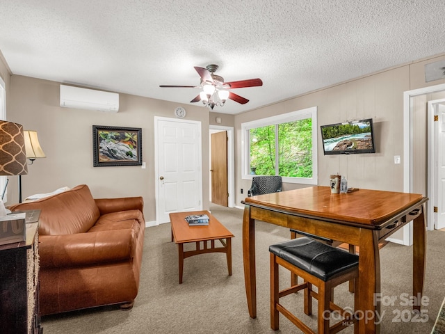living area featuring carpet flooring, an AC wall unit, ceiling fan, and a textured ceiling