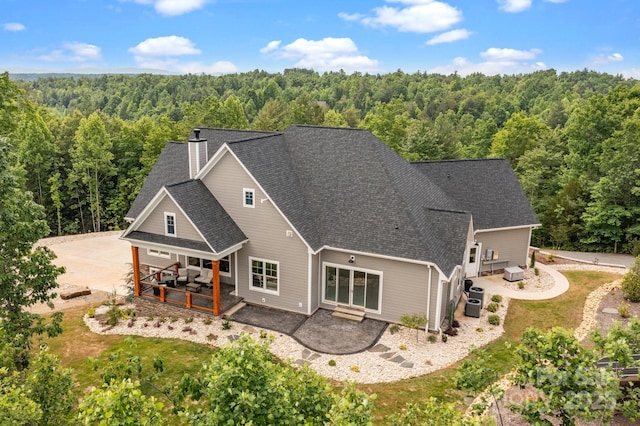 5360 Low Country Rd, Lenoir, NC 28645 - back of house with a view of trees, a patio, a chimney, and a shingled roof