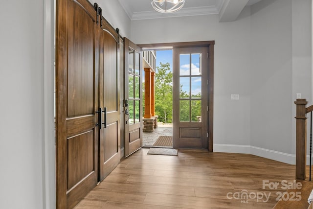 5360 Low Country Rd, Lenoir, NC 28645 - entrance foyer featuring light wood-type flooring, ornamental molding, a barn door, and baseboards