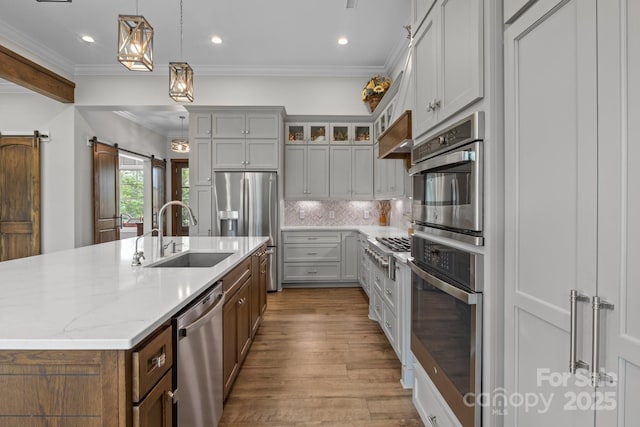5360 Low Country Rd, Lenoir, NC 28645 - kitchen featuring a sink, stainless steel appliances, crown molding, wood finished floors, and a kitchen island with sink