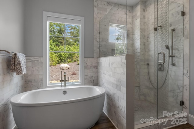 5360 Low Country Rd, Lenoir, NC 28645 - bathroom with healthy amount of natural light, tile walls, a freestanding tub, a shower stall, and a wainscoted wall