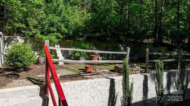 view of yard with an outdoor fire pit