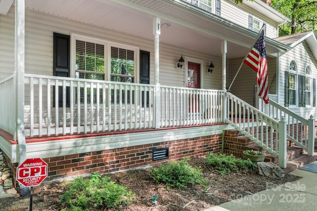view of exterior entry with a porch