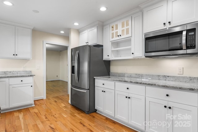 kitchen featuring stainless steel appliances, baseboards, recessed lighting, white cabinetry, and light wood-type flooring
