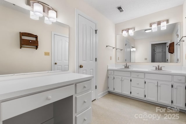 full bathroom featuring visible vents, a sink, baseboards, and double vanity