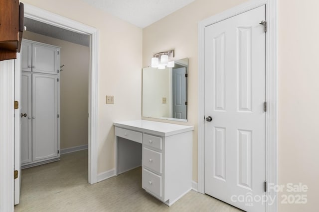 bathroom with baseboards and vanity