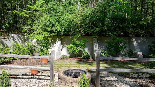 view of yard featuring a water view and a fire pit