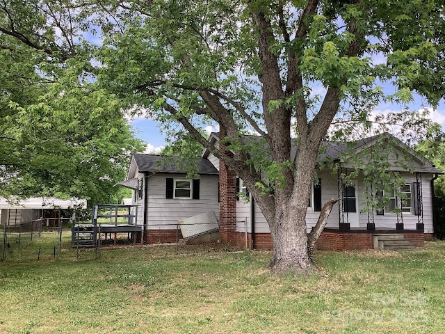 back of property featuring a yard, fence, and a porch
