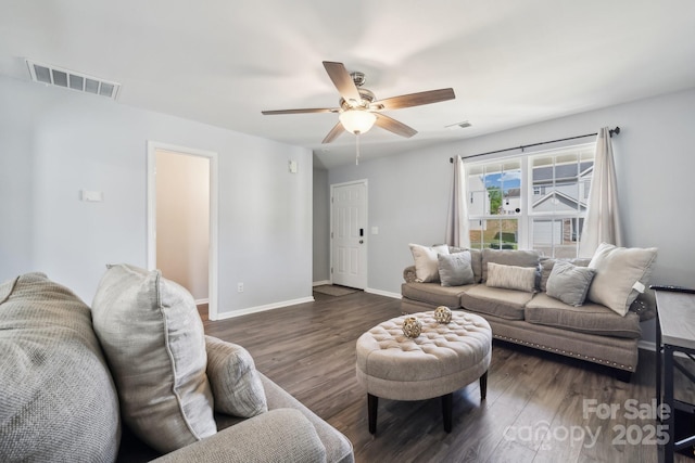 living room with a ceiling fan, visible vents, wood finished floors, and baseboards