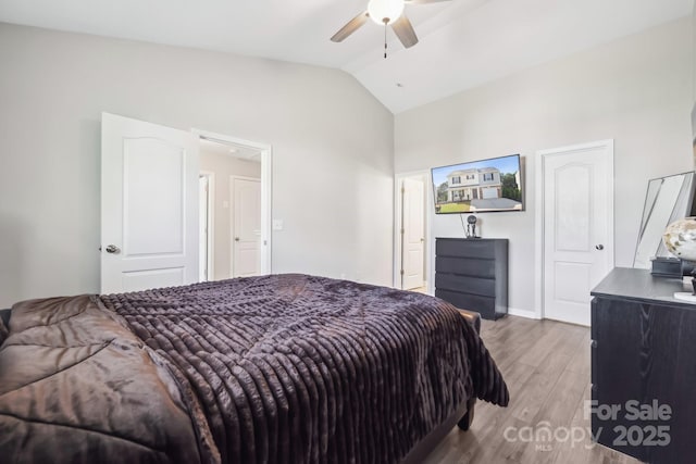 bedroom featuring lofted ceiling, wood finished floors, a ceiling fan, and baseboards