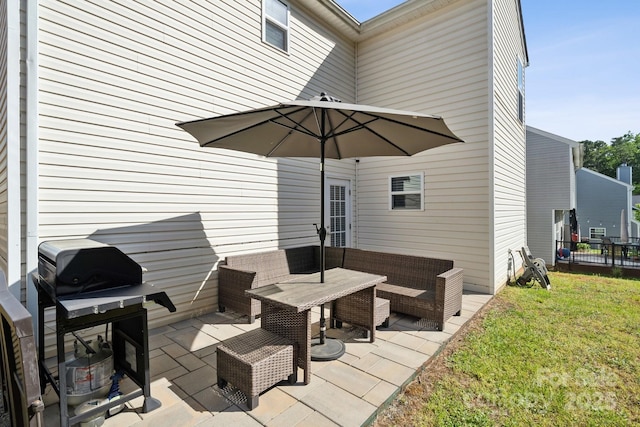 view of patio with a grill and fence
