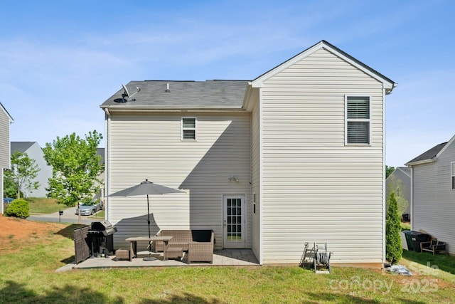 rear view of house featuring a patio and a yard
