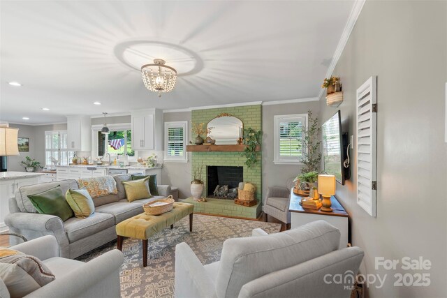 530 Bonita Dr, Landis, NC 28088 - living area featuring crown molding, a chandelier, plenty of natural light, a brick fireplace, and recessed lighting