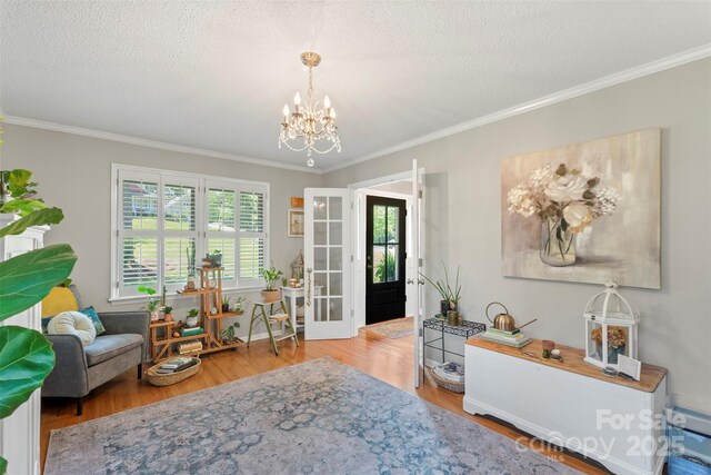 530 Bonita Dr, Landis, NC 28088 - living area featuring ornamental molding, a chandelier, wood finished floors, and a textured ceiling