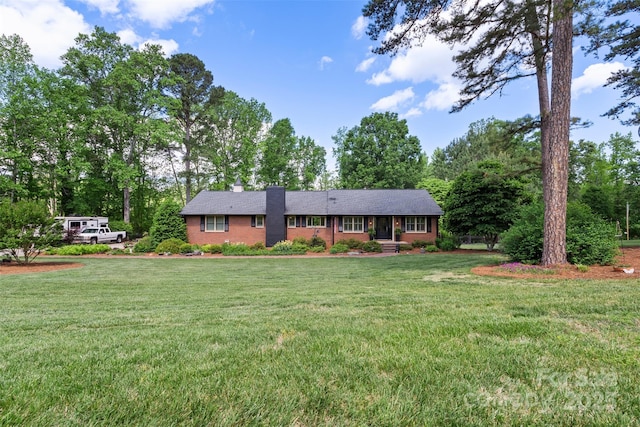 530 Bonita Dr, Landis, NC 28088 - single story home featuring a front lawn, a chimney, brick siding, and view of wooded area