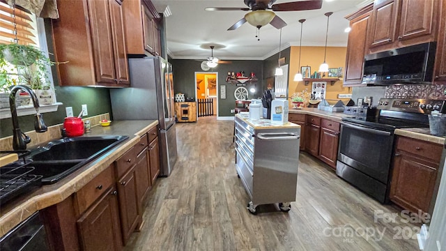 5562 Jenkins Rd, Morganton, NC 28655 - kitchen with light wood-style flooring, ornamental molding, ceiling fan, a sink, and stainless steel appliances