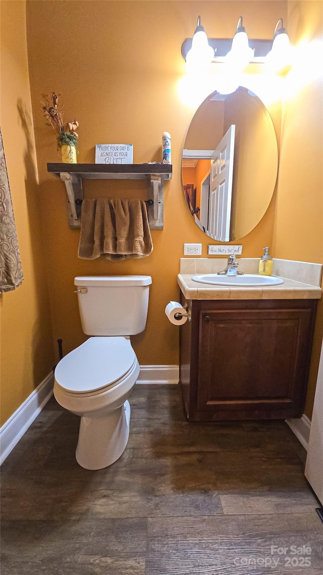 5562 Jenkins Rd, Morganton, NC 28655 - half bathroom with toilet, baseboards, vanity, and wood finished floors