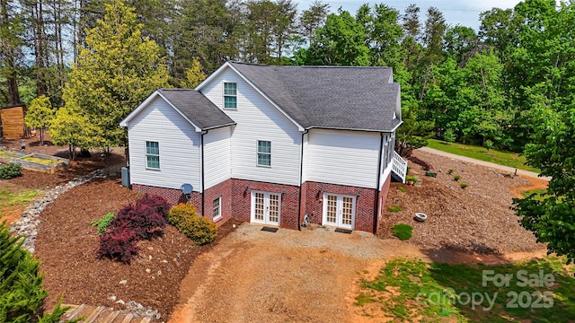 5562 Jenkins Rd, Morganton, NC 28655 - view of home's exterior featuring brick siding, driveway, french doors, and roof with shingles