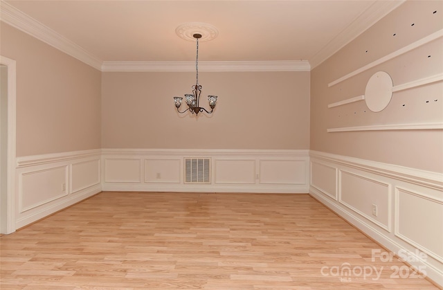 1142 Ardwyck Pl Unit 5, Rock Hill, SC 29730 - spare room with ornamental molding, a chandelier, light wood-style flooring, wainscoting, and a decorative wall