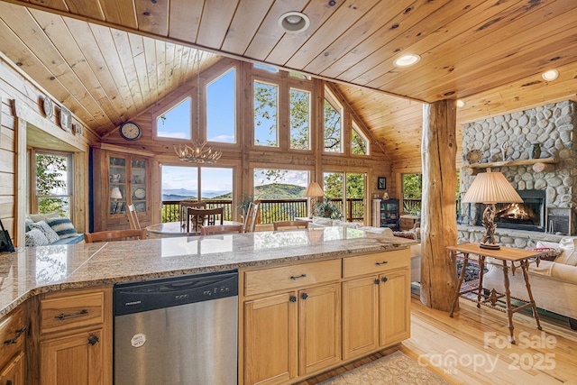 kitchen with stainless steel dishwasher, a fireplace, open floor plan, wooden ceiling, and light wood finished floors