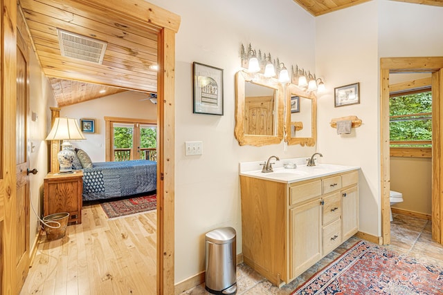 ensuite bathroom featuring visible vents, a sink, wooden ceiling, lofted ceiling, and ensuite bath