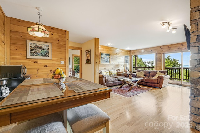 dining space featuring wood walls and wood finished floors