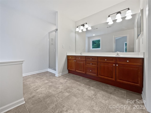bathroom featuring a sink, double vanity, tile patterned floors, baseboards, and a stall shower