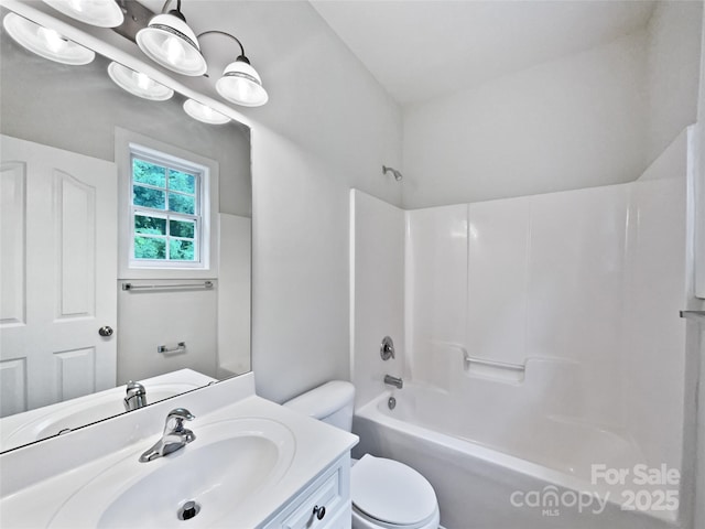 bathroom featuring vanity, toilet, and shower / washtub combination