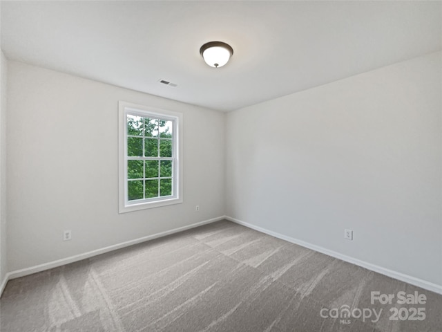 carpeted empty room with baseboards and visible vents