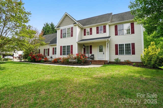 view of front of home featuring covered porch, roof with shingles, and a front lawn
