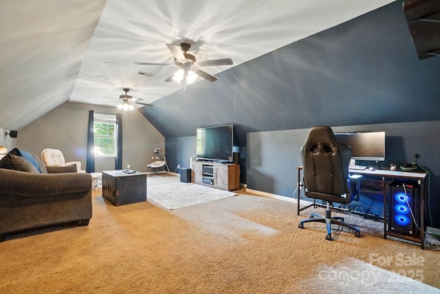 carpeted office space featuring ceiling fan, visible vents, and lofted ceiling