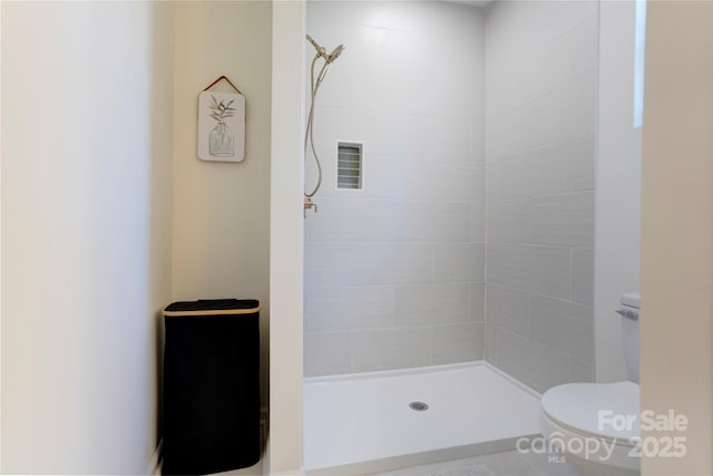 bathroom with toilet and a stall shower