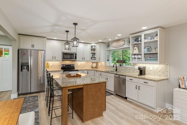 4329 Island Ford Rd, Brevard, NC 28712 - kitchen featuring appliances with stainless steel finishes, light wood finished floors, a sink, light stone counters, and recessed lighting