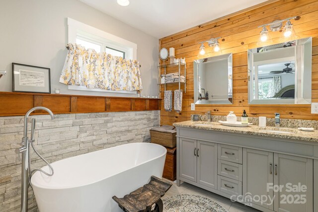 4329 Island Ford Rd, Brevard, NC 28712 - full bath featuring wood walls, double vanity, a freestanding bath, tile patterned flooring, and ceiling fan